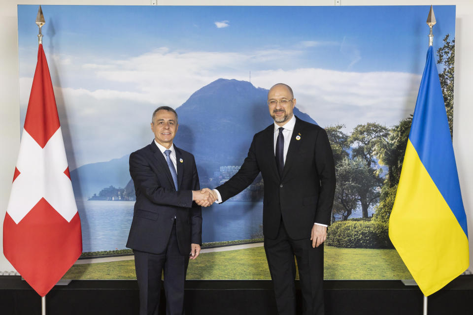 Swiss President Ignazio Cassis, Minister of Foreign Affairs, left, welcomes Ukrainian Prime Minister Denys Shmyhal to the Ukraine Recovery Conference URC, on Monday, July 4, 2022 in Lugano, Switzerland. The URC is organised to initiate the political process for the recovery of Ukraine after the attack of Russia to its territory. (Michael Buholzer/Keystone via AP)