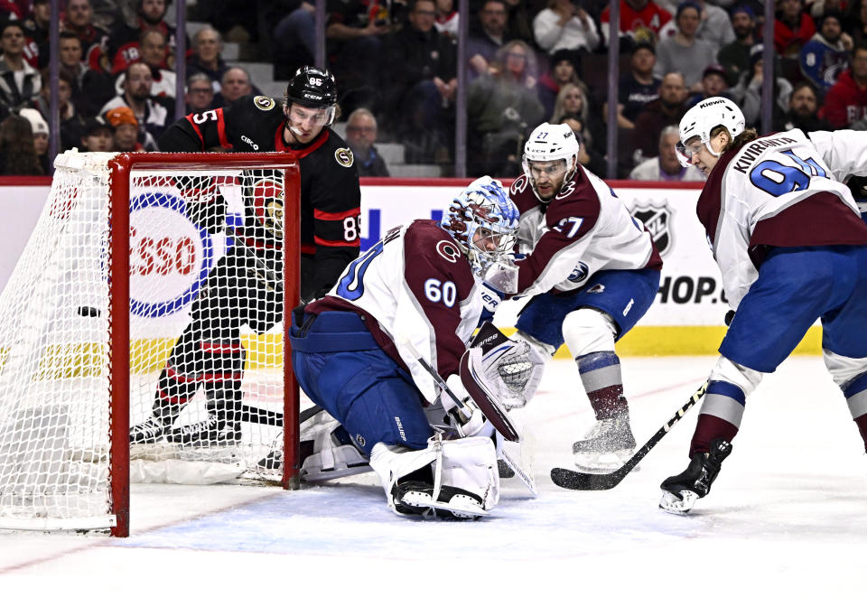 Ottawa Senators defenseman Jake Sanderson (85) watches his shot go in the back of the net behind Colorado Avalanche goaltender Justus Annunen (60) during the second period of an NHL hockey game, Tuesday, Jan. 16, 2024 in Ottawa, Ontario. (Justin Tang/The Canadian Press via AP)