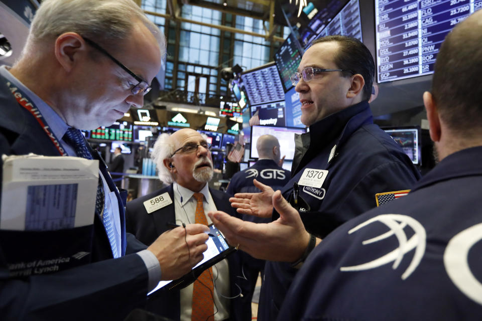 Specialist Anthony Matesic, right, works with traders on the floor of the New York Stock Exchange, Friday, Feb. 15, 2019. Stocks are opening higher on Wall Street after Chinese and U.S. officials agreed to continue trade talks in Washington next week. (AP Photo/Richard Drew)