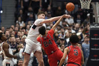 UConn's Donovan Clingan, left, fouls St. John's Rafael Pinzon in the second half of an NCAA college basketball game, Sunday, Jan. 15, 2023, in Hartford, Conn. (AP Photo/Jessica Hill)