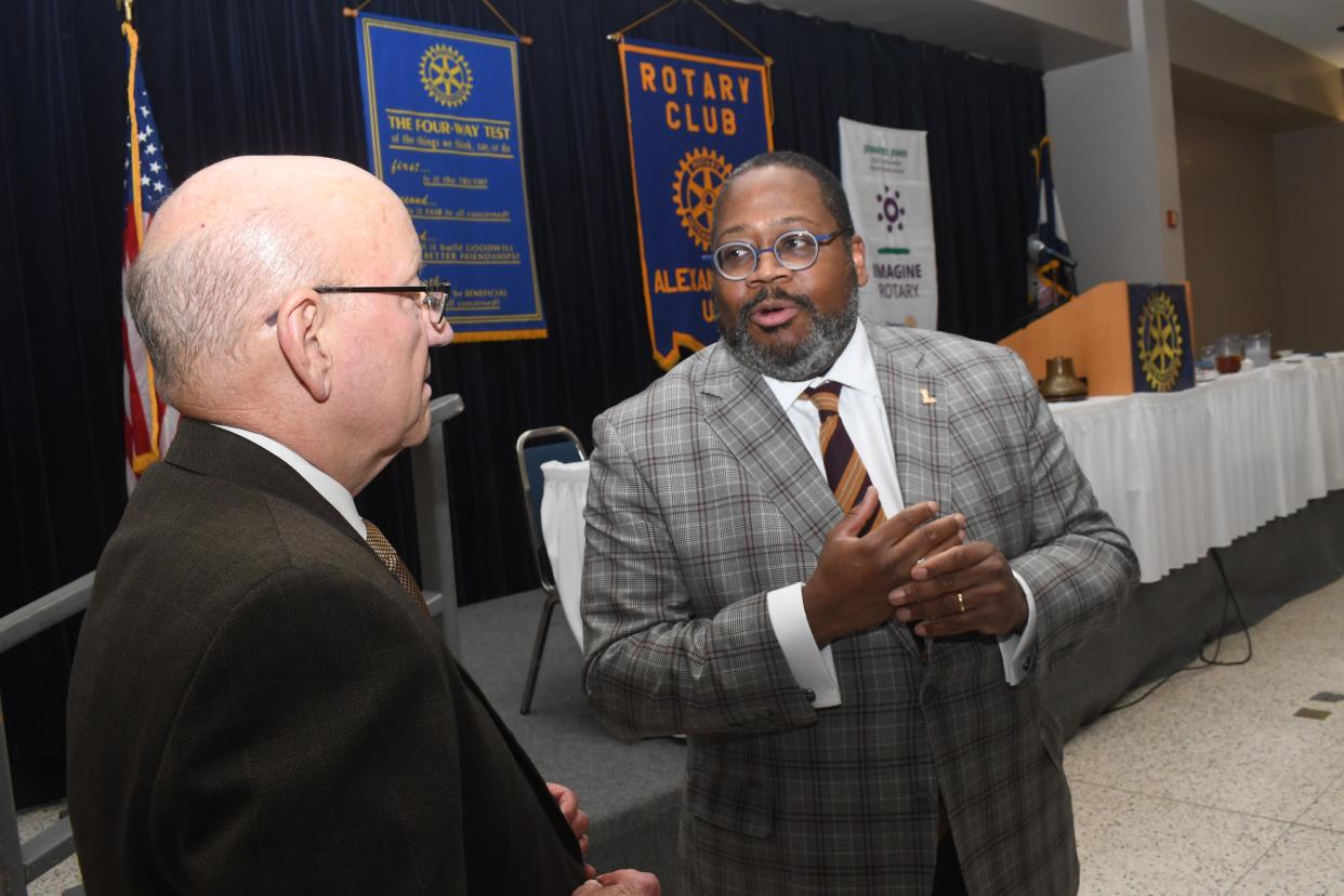 Dr. Xavier Cole (right), new president of Loyola University New Orleans, talks with Dr. Paul Coreil, chancellor of LSU at Alexandria. Cole was the guest speaker at the Rotary Club of Alexandria's weekly luncheon.