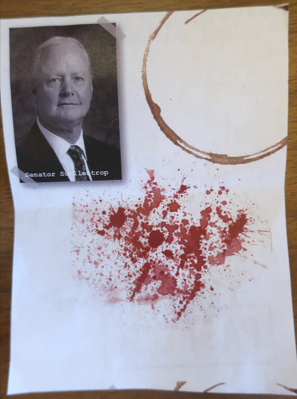Pictured is one of several thousand leaflets dropped in the Statehouse rotunda in Topeka, Kansas, to protest in favor of Medicaid expansion Friday, May 3, 2019. This leaflets contains a picture of Senate health committee Chairman Gene Suellentrop, R-Wichita, who opposes expansion, and a spattering of blood. (AP Photo/John Hanna)