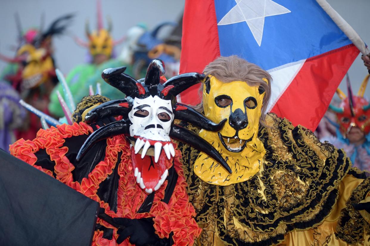 people in costumes and masks at ponce carnival, 2016