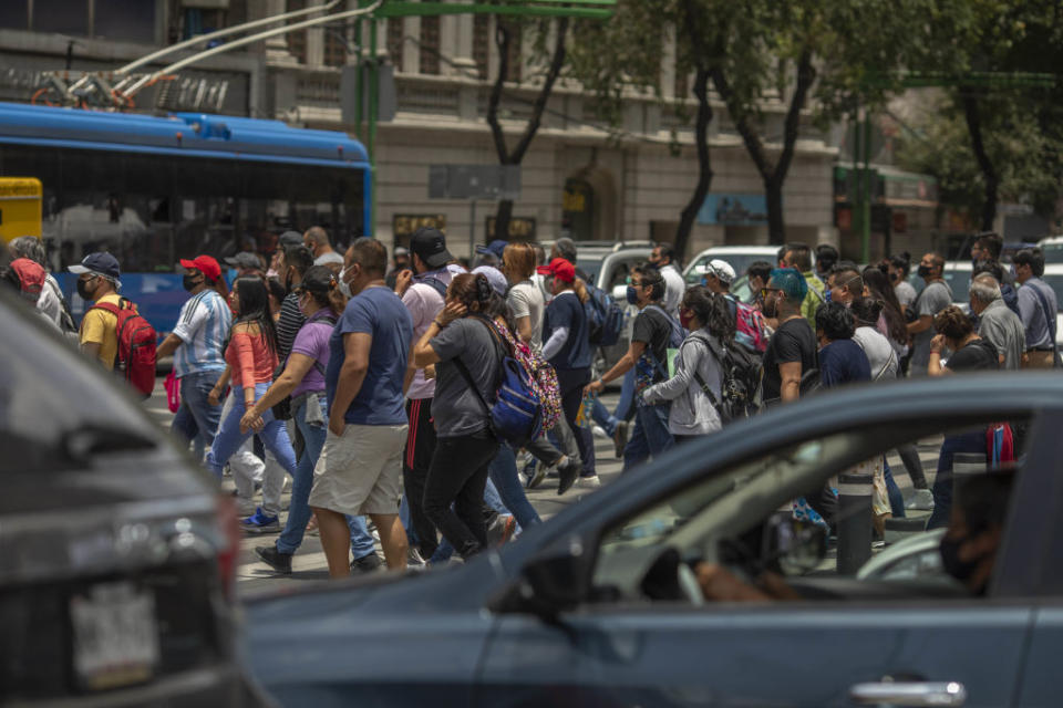 Dozens of pedestrians cross Eje Central Avenue in Mexico City on Wednesday.