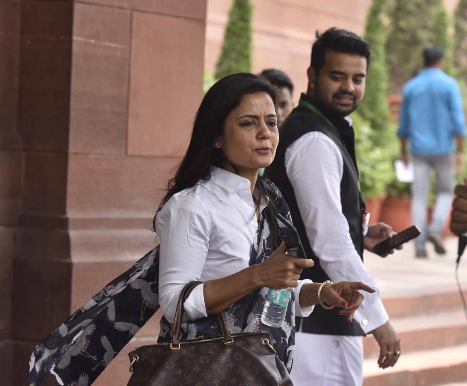 Indian Member of Parliament Mahua Moitra speaks to journalists as her fellow parliamentarian, Janata Dal (Secular) MP Prajwal Revanna, looks on after attending a budgetary session at Parliament House, June 26, 2019, in New Delhi, India. / Credit: Sonu Mehta/Hindustan Times/Getty