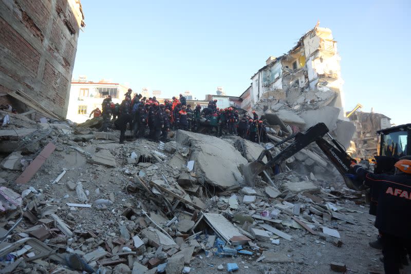 Rescuers work on a collapsed building after an earthquake in Elazig