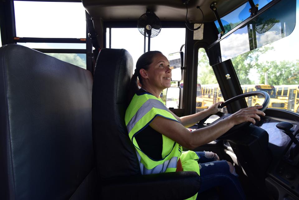 Nancy Whitmore, a school bus driver and trainer for the Port Huron School District, 
checks her rearview mirror before driving during a training exercise at the Port Huron Area School District Bus Depot on Thursday, August 11, 2022.