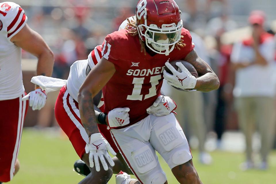 Oklahoma's Jadon Haselwood (11) runs after a reception a college football game between the University of Oklahoma Sooners (OU) and the Nebraska Cornhuskers at Gaylord Family-Oklahoma Memorial Stadium in Norman, Okla., Saturday, Sept. 18, 2021. Oklahoma won 23-16. 