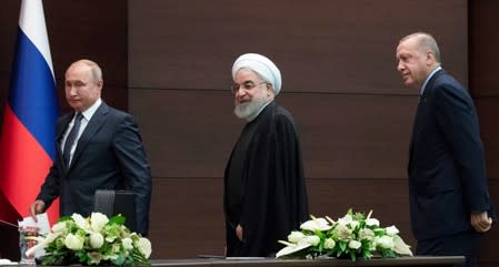 Presidents Hassan Rouhani of Iran, Tayyip Erdogan of Turkey and Vladimir Putin of Russia leave a news conference during their meeting in Ankara