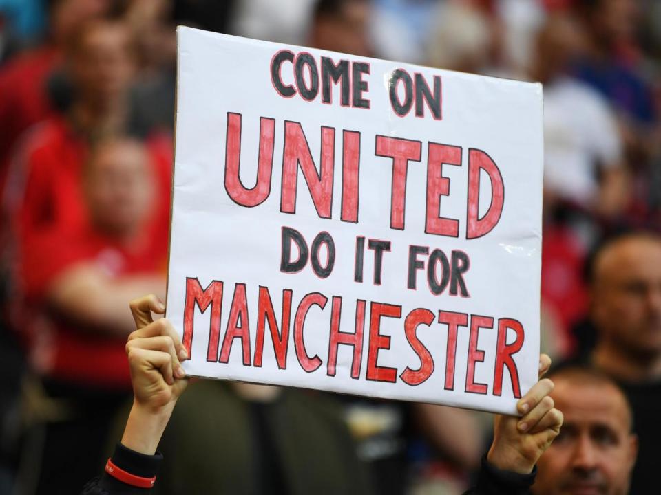 A United fan shows support for his team prior to kick-off (Getty)