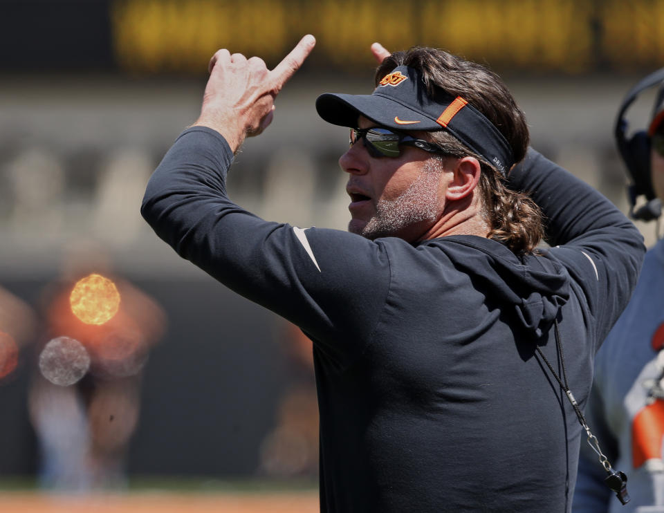 Oklahoma State head coach Mike Gundy gestures to his team during an NCAA college football intra-squad scrimmage in Stillwater, Okla., Saturday, April 28, 2018. (AP Photo/Sue Ogrocki)