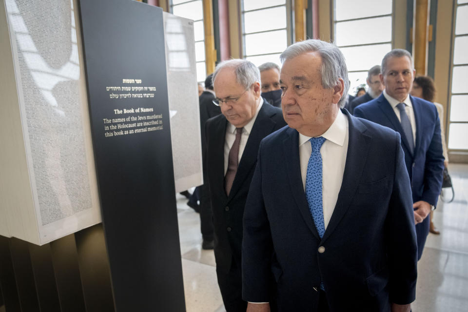 Antonio Guterres, United Nations Secretary General, center, Dani Dayan, Chairman of Yad Vashem, left, and Gilad Erdan, Permanent Representative of Israel to the United Nations, right, walk along the Yad Vashem Book of Names of Holocaust Victims Exhibit, Thursday, Jan. 26, 2023, at United Nations headquarters. (AP Photo/John Minchillo)