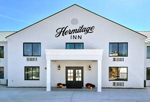 Hermitage Inn & Taphouse is newly renovated and features a white brick exterior.