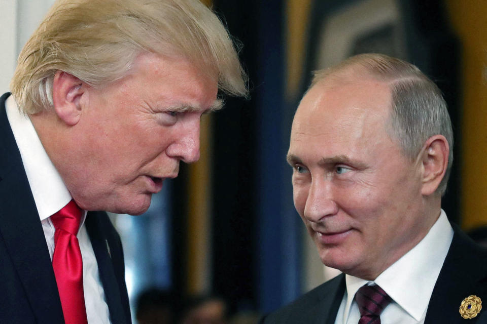 Donald Trump, left, chats with Vladimir Putin (Mikhail Klimentyev / AFP via Getty Images)