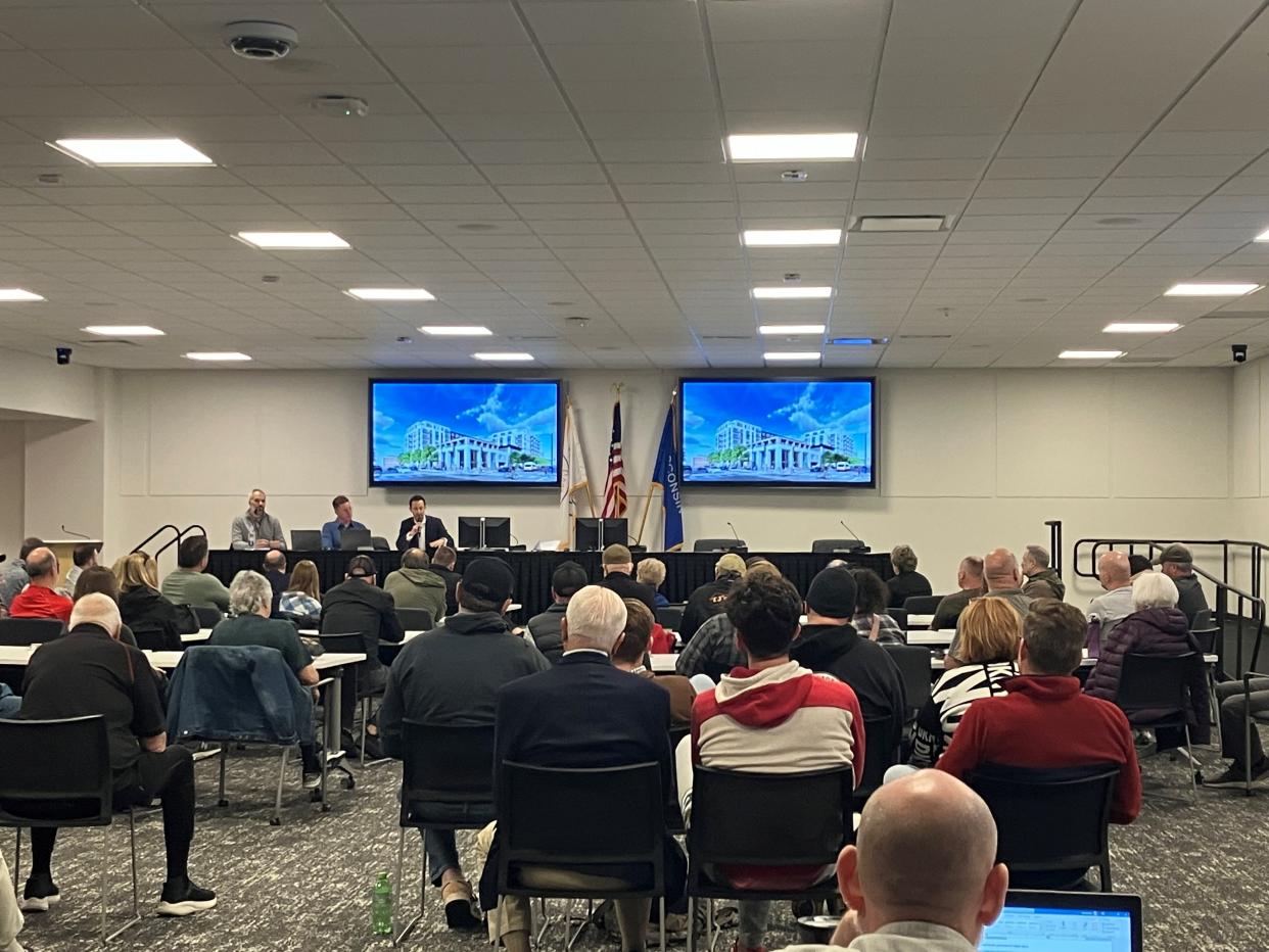 New Land Enterprises officials discuss plans for an 8-story apartment building in downtown Green Bay with nearby business owners, residents, property owners and churchgoers during an April 19 community meeting at the Brown County Library.