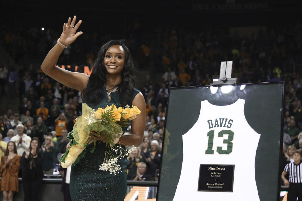 Former Baylor All-American Nina Davis waves to the crowd after having her jersey retired before in an NCAA college basketball game against West Virginia, Saturday, Jan. 18, 2020, in Waco, Texas. (AP Photo/Rod Aydelotte)
