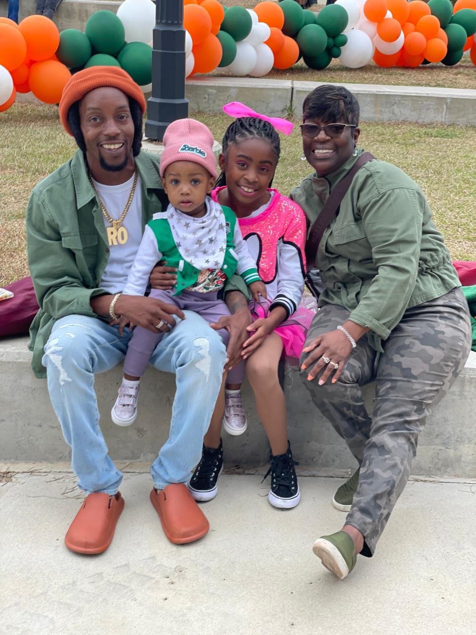 Demario “Ro” Murray, with his two young daughters and mother.