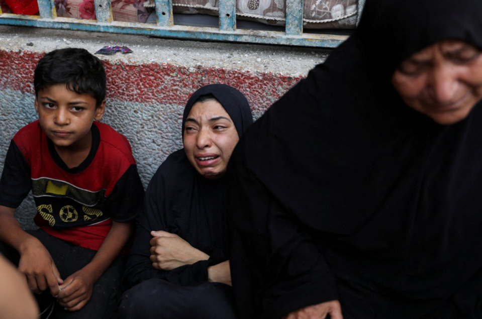 A woman mourns at the site of an Israeli attack on a UN school in Nuseirat refugee camp.