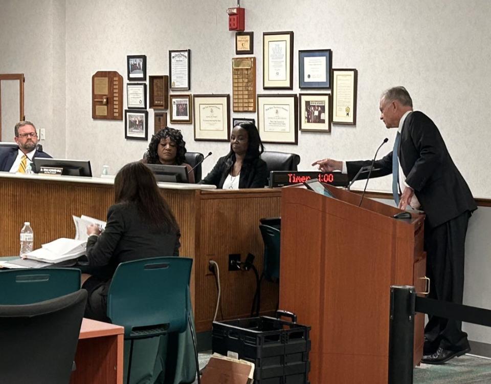 SCCPSS School Board Attorney Leamon Holliday, III (right) leans in to ask former Butler Elementary principal Latila Slay to read from a document during Slay's employment hearing on Oct. 12, 2023 at the Whitney Administrative Complex