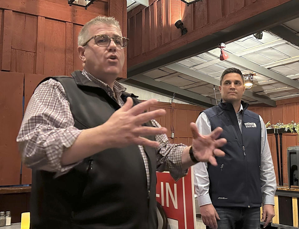 Congressional candidate Darren Bailey, left, campaigns with state Rep. Adam Niemerg at a local restaurant meet-and-greet, Tuesday, Feb. 27, 2024, in Casey, Ill. Bailey, a former state senator and 2022 Republican nominee for governor, is running in the March 19th primary to unseat fellow GOP Congressman Mike Bost, a five-term incumbent who has the endorsement of former President Donald Trump, in Illinois' 12th District, which encompasses the bottom one-third of Illinois. (AP Photo/John O'Connor)