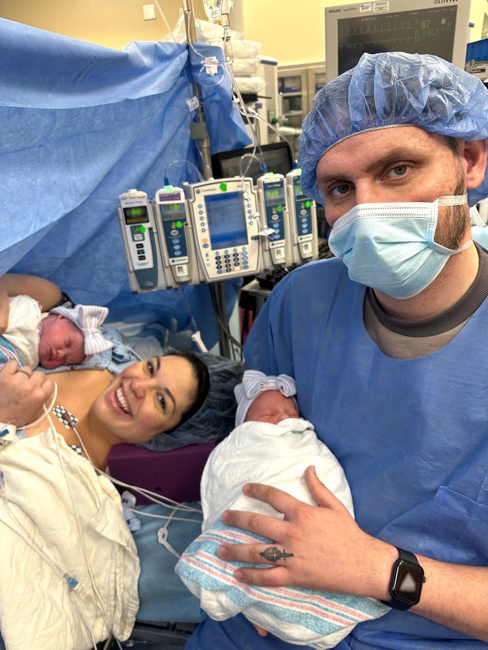 Kelsey Hatcher and her husband, Caleb hold their twin daughters Roxi Layla, right, and Rebel Laken on Wednesday. Hatcher, 32, from Alabama who was born with two uteruses and became pregnant in both, gave birth to twin girls on different days, she announced on Friday.