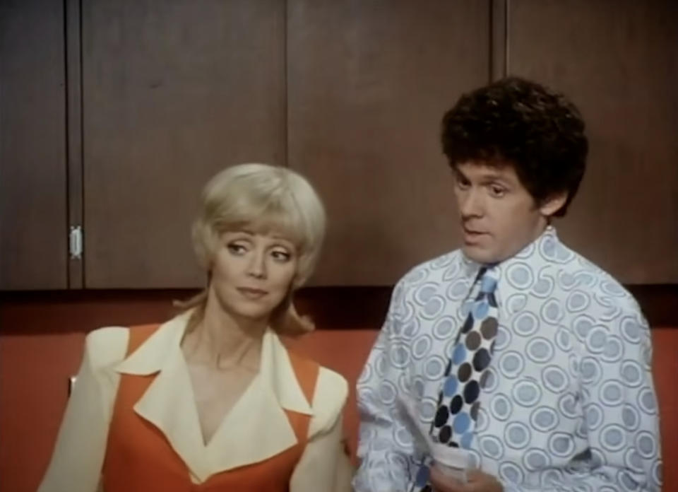 Suzanne Somers in a retro blouse and John Ritter in a quirky patterned shirt in a still from their popular TV show