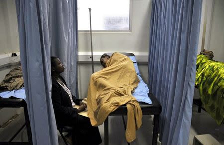 An attendant cares for a patient infected with HIV/AIDS in a ward of Uganda's Infectious Disease Institute in the capital Kampala, in this June 5, 2008 file photo. REUTERS/James Akena/Files