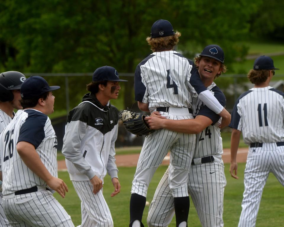 Granville pitcher Andrew Nemec (24) is hugged by second baseman Dylan Andrews (4), after completing a 3-hitter in the 1-0 Division II district semifinal win against Bloom-Carroll.