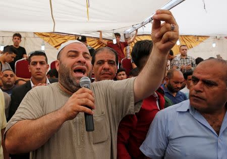 The father of Mohammad Jawawdah speaks at his funeral in Amman, Jordan July 25, 2017. REUTERS/Muhammad Hamed