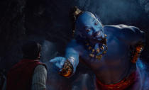 This image released by Disney shows Mena Massoud as Aladdin, left, and Will Smith as Genie in Disney's live-action adaptation of the 1992 animated classic "Aladdin." (Disney via AP)