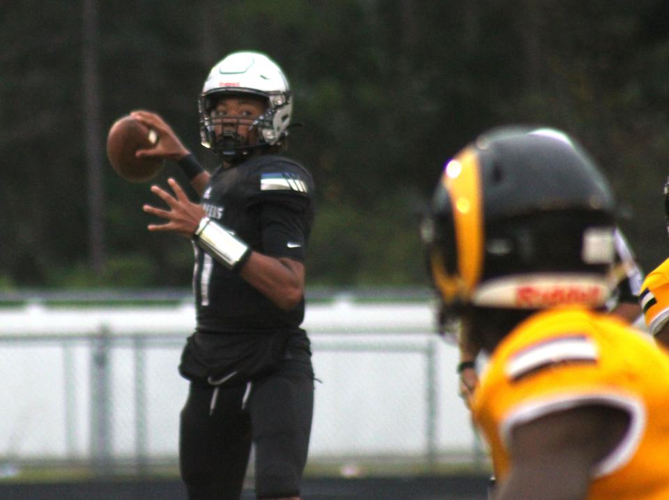 First Coast quarterback Rodney Tisdale Jr. (11) takes aim downfield against Englewood  during a high school football game on October 3, 2022. [Clayton Freeman/Florida Times-Union]