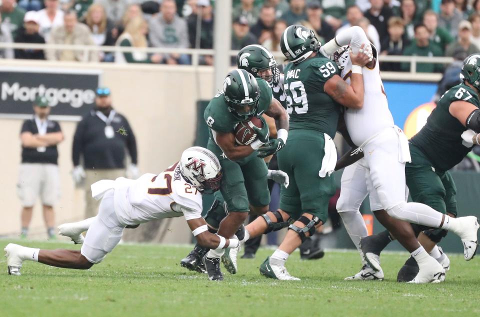 Michigan State running back Jalen Berger is tackled by Minnesota defensive back Tyler Nubin during the first half on Saturday, Sept. 24, 2022, in East Lansing.