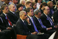 United States Attorney General Eric Holder rubs his eye while sitting next to Kansas Gov. Sam Brownback during an Interfaith Service of Unity and Hope at the Jewish Community Center in Overland Park, Kan., Thursday, April 17, 2014. Frazier Glenn Cross, 73, is charged with the killings Sunday of Dr. William Lewis Corporon and his grandson, Reat Griffin Underwood, outside the Jewish Community Center of Greater Kansas City. Cross is also accused of killing Terri LaManno at a nearby Jewish retirement complex. (AP Photo/Orlin Wagner)