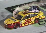 Joey Logano (22) does a burnout after winning the NASCAR Cup Series championship auto race at Homestead-Miami Speedway, Sunday, Nov. 18, 2018, in Homestead, Fla. (AP Photo/David Graham)