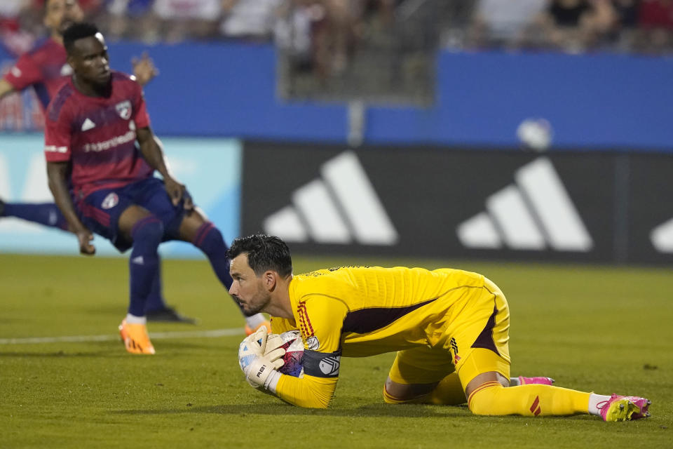 Sporting Kansas City goalkeeper John Pulskamp,right, stops an attack during the first half of an MLS soccer match against FC Dallas Saturday, May 6, 2023, in Frisco, Texas. (AP Photo/LM Otero)