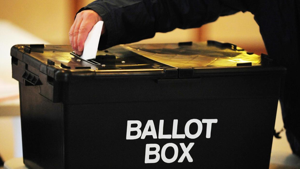 A voter placing a ballot paper in the ballot box