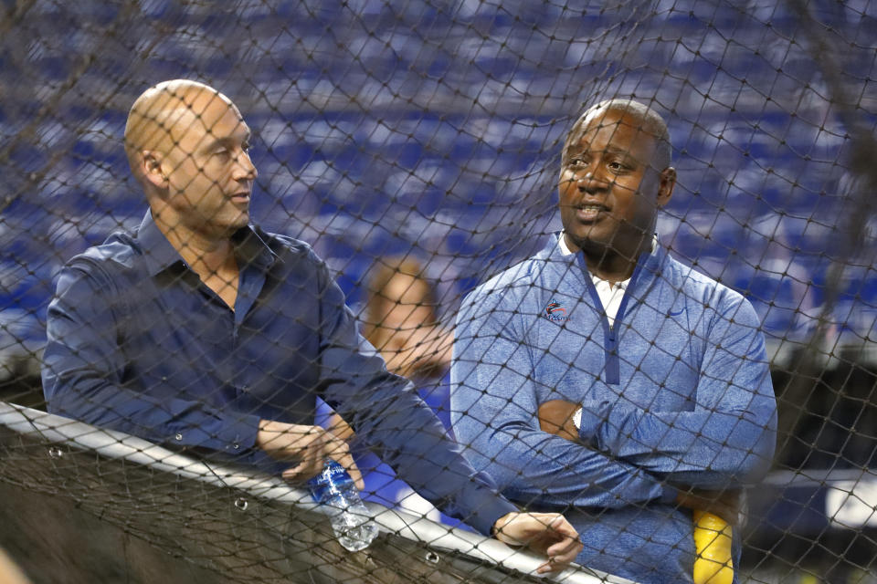 FILE - In this Wednesday, Aug. 28, 2019, file photo, Miami Marlins CEO Derek Jeter, left, and Michael Hill, President of Baseball Operations, watch batting practice before the start of a baseball game against the Cincinnati Reds, in Miami. Marlins executive Michael Hill's 19-season tenure with the franchise has ended. Hill was president of baseball operations for the past six years and provided continuity after a 2017 change in ownership, but he will not be back next year, CEO Derek Jeter said Sunday, Oct. 18, 2020.(AP Photo/Wilfredo Lee, File)