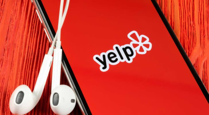 yelp app on a mobile phone with headphones