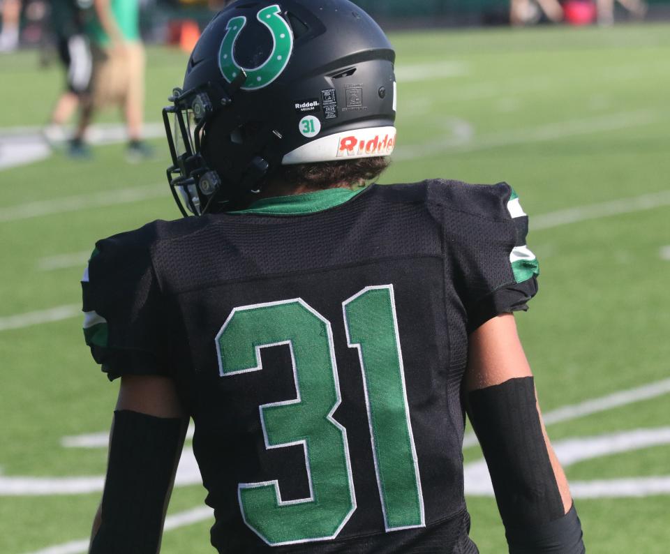 Clear Fork senior Kasey Swank sports his late father's No. 31 along with a helmet decal dedicated to 2002 alum Charles Swank, who died in December.