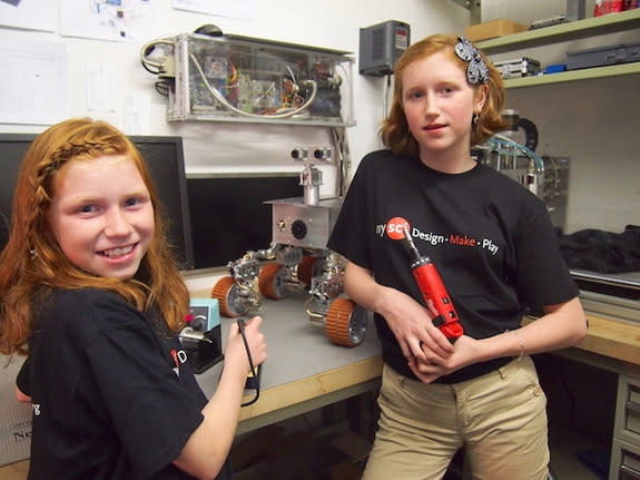 Camille (right) and Genevieve Beatty in the Beatty Robotics Lab. Their Mars rover, commissioned by the New York Hall of Science, stands on the workbench. The rover was installed at the NY Hall of Science on June 8, 2013.