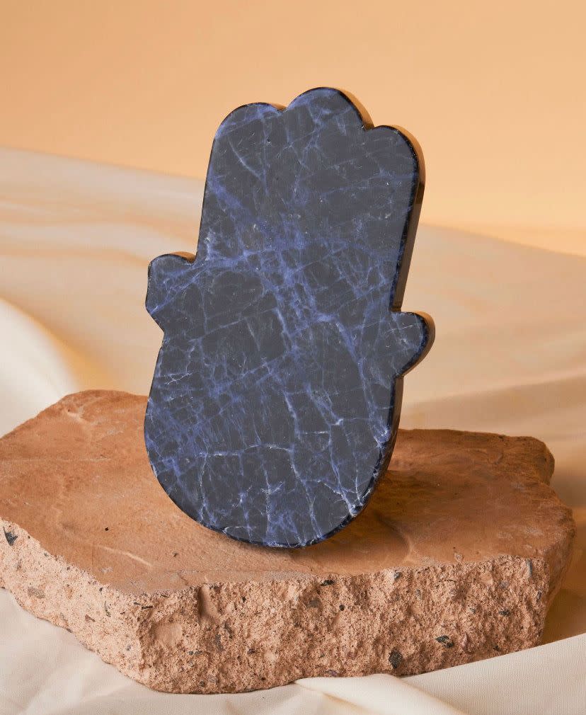 <p><a href="https://heritage-apothecary.com/products/sodalite-crystal-hamsa-hand" rel="nofollow noopener" target="_blank" data-ylk="slk:Shop Now;elm:context_link;itc:0;sec:content-canvas" class="link ">Shop Now</a></p><p>Sodalite Crystal Hamsa Hand</p><p>heritage-apothecary.com</p><p>$74.00</p>