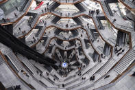 FILE - In this March 15, 2019, file photo visitors to "Vessel" climb its staircases on its opening day at Hudson Yards in New York. The shareholder comes first has for years been the mantra of the Business Roundtable, a group representing the most powerful CEOs in America. The group on Monday, Aug. 19, released a new mission statement that implies a foundational shift; a step back from shareholder primacy. (AP Photo/Mark Lennihan, File)