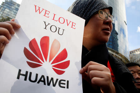 Lisa Duan, a visitor from China, holds a sign in support of Huawei outside of the B.C. Supreme Court bail hearing of Huawei CFO Meng Wanzhou, who is being held on an extradition warrant in Vancouver, British Columbia, Canada December 10, 2018. REUTERS/David Ryder