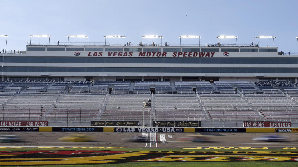 Drivers pass the start finish line during a NASCAR Cup Series auto race Sunday, Sept. 27, 2020, in Las Vegas. The race was run without fans due to COVID-19. (AP Photo/Isaac Brekken)