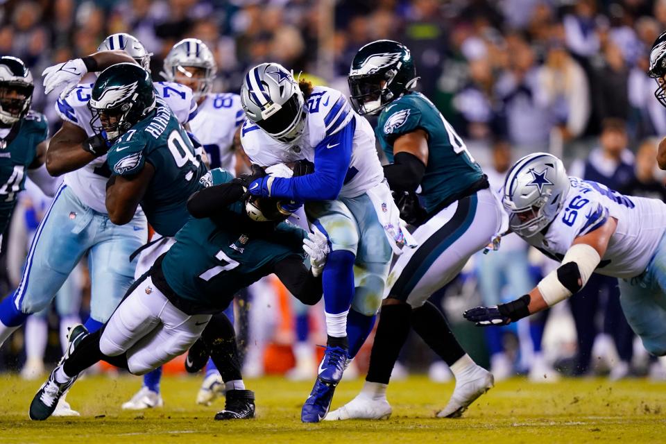 Dallas Cowboys' Ezekiel Elliott is brought down by Philadelphia Eagles' Haason Reddick during the second half of an NFL football game Sunday, Oct. 16, 2022, in Philadelphia.