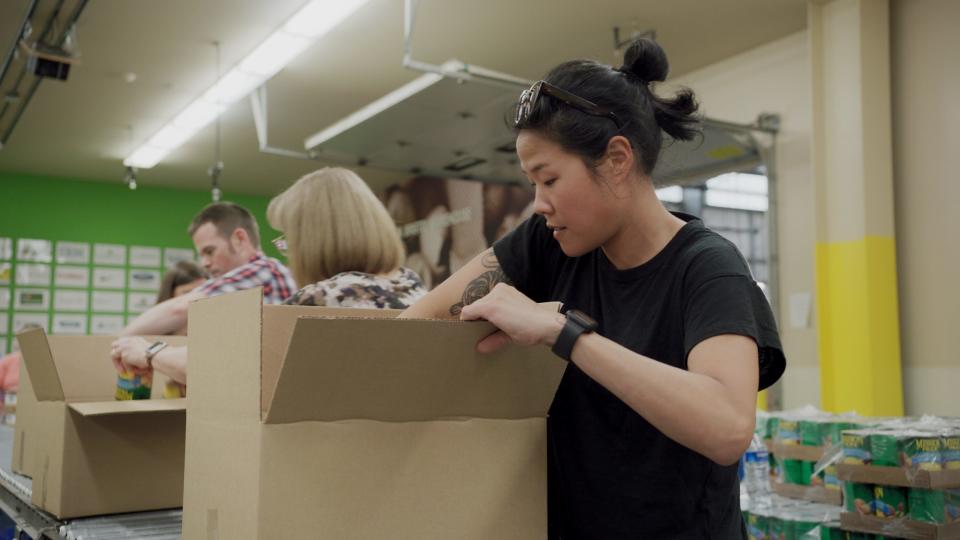 A volunteer packs boxes at Oregon Food Bank.