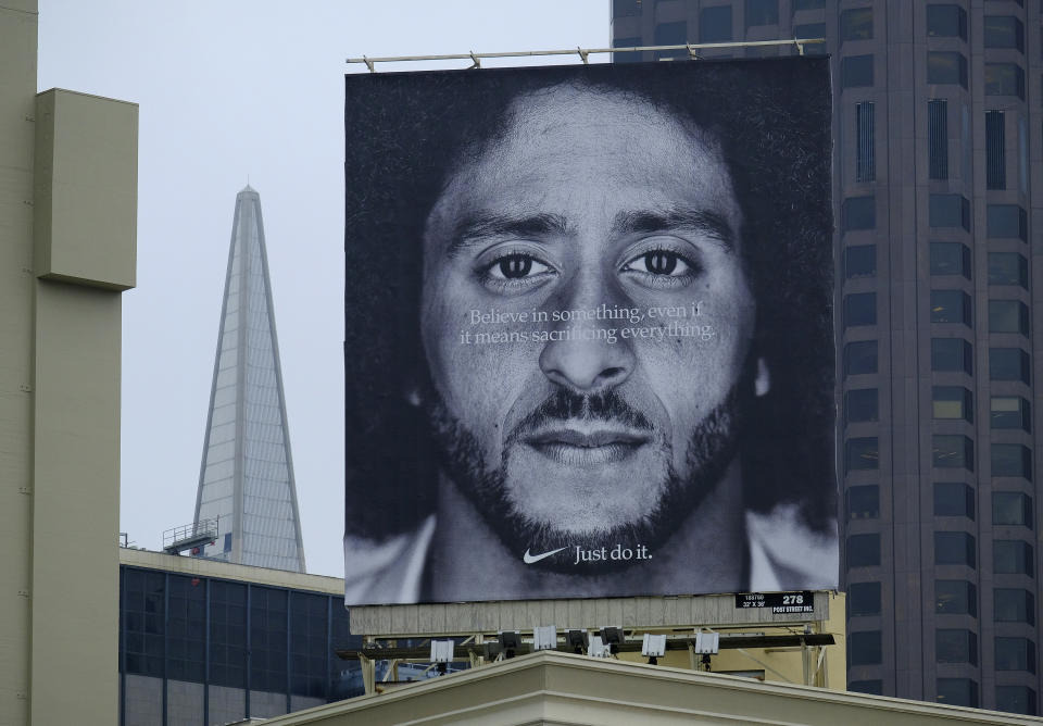 FILE - In this Sept. 5, 2018, file photo, a large billboard stands on top of a Nike store showing former San Francisco 49ers quarterback Colin Kaepernick, at Union Square in San Francisco. Nike is pulling a flag-themed tennis shoe after Kaepernick complained to the shoemaker, according to the Wall Street Journal. (AP Photo/Eric Risberg, File)