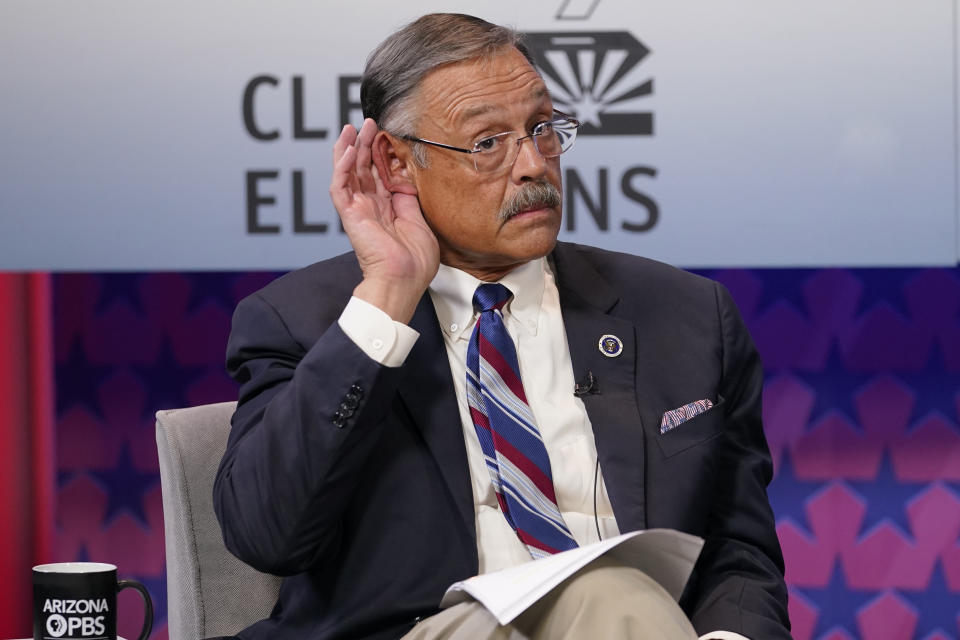 FILE - Arizona Secretary of State Republican candidate Mark Finchem listens to instructions prior to debating Democratic challenger Adrian Fontes, on Sept. 22, 2022, in Phoenix. Races for secretary of state offices are some of the most consequential contests on the ballot. (AP Photo/Matt York, File)