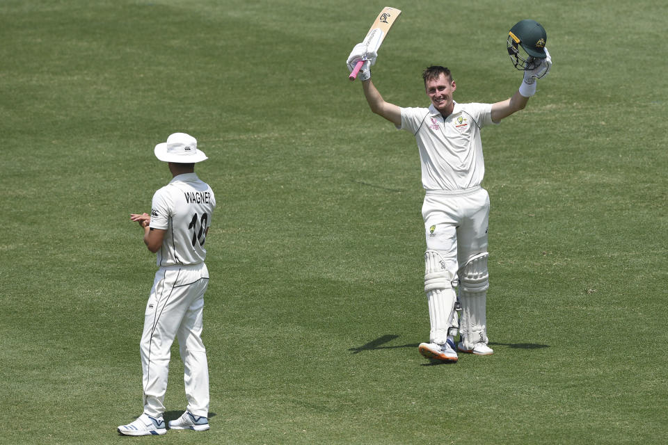 Australia's Marnus Labuschagne celebrates his double century 200 not out, next to New Zealand's Neil Wagner, left, on day two of the third cricket test match between Australia and New Zealand at the Sydney Cricket Ground in Sydney, Saturday, Jan. 4, 2020. (Andrew Cornaga/Photosport via AP)