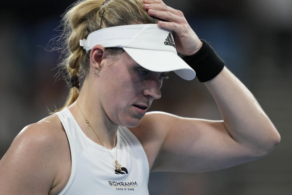 Germany's Angelique Kerber hold her head after losing the first set to Italy's Jasmine Paolini during the United Cup tennis tournament in Sydney, Saturday, Dec. 30, 2023. (AP Photo/Rick Rycroft)